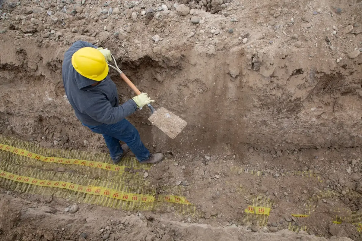 Colour-coded ground markings showing pipes and cables before an excavation in Quebec City